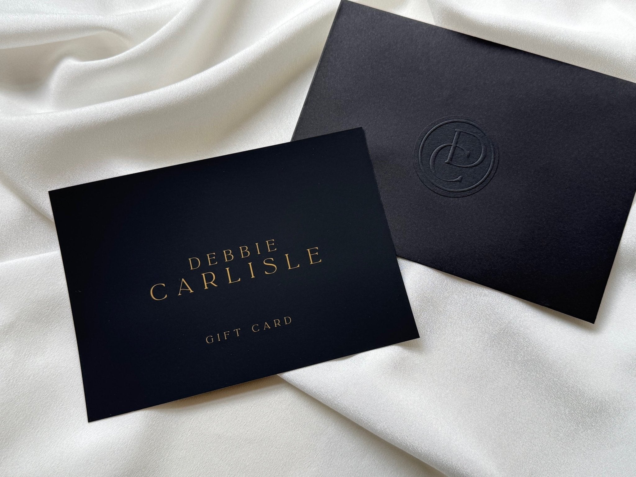 Debbie Carlisle gift card in black with gold foil logo